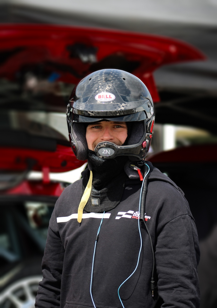 Michael Myers in racing helmet, paddock portrait